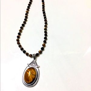 Beaded necklace with pendant and matching earrings.